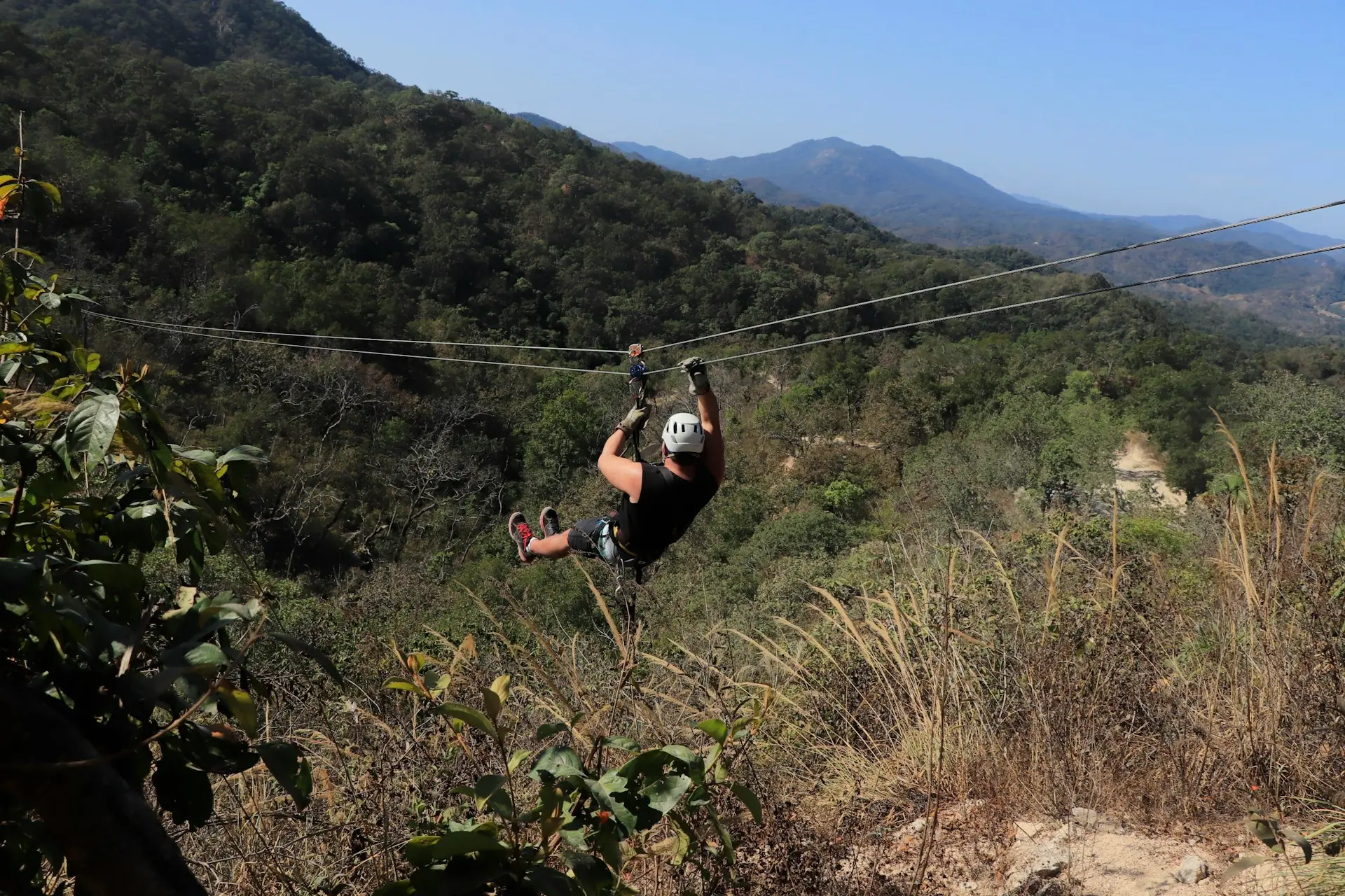 a man is zipping through the air on a rope